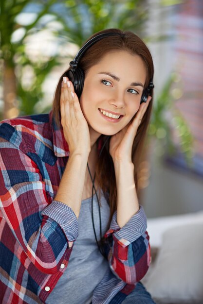 Young happy woman wearing headphones