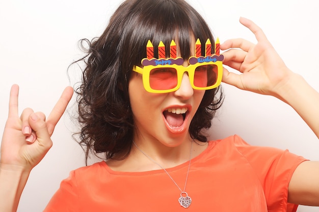 Young happy woman with big orange sunglasses, ready for party