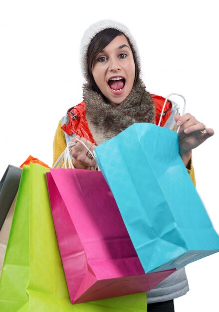 Young happy woman with shopping bags, on white