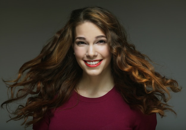 Young happy woman with wind in hair 