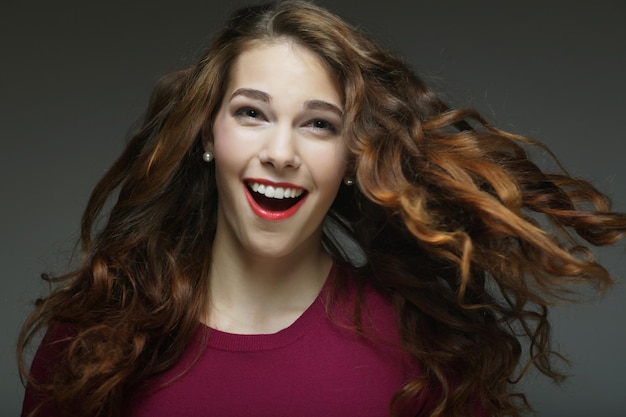 Young happy woman with wind in hair