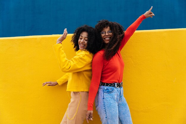 Young happy women dancing and having fun outdoor