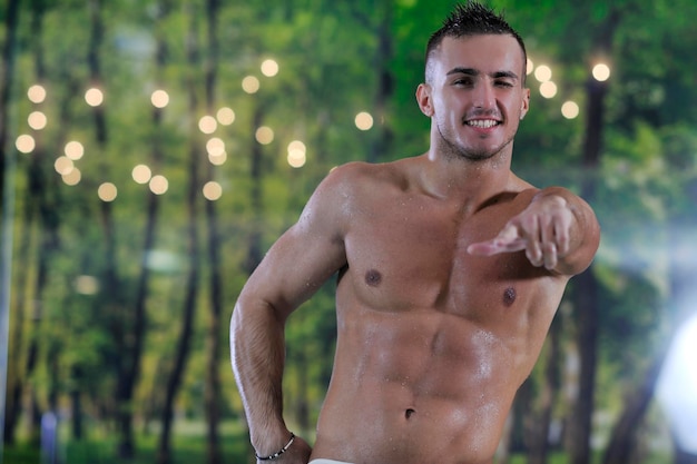 young healthy good looking macho man model athlete at hotel indoor pool