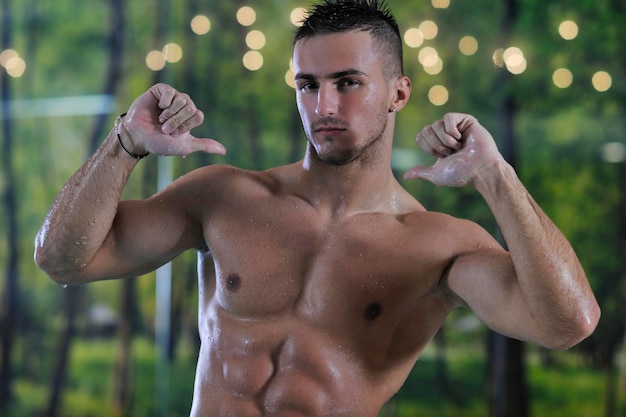 young healthy good looking macho man model athlete at hotel indoor pool