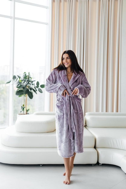 Young healthy serene woman girl relaxing in bathrobe and spa towel after having bath shower at home Beauty treatment rest and body care procedures