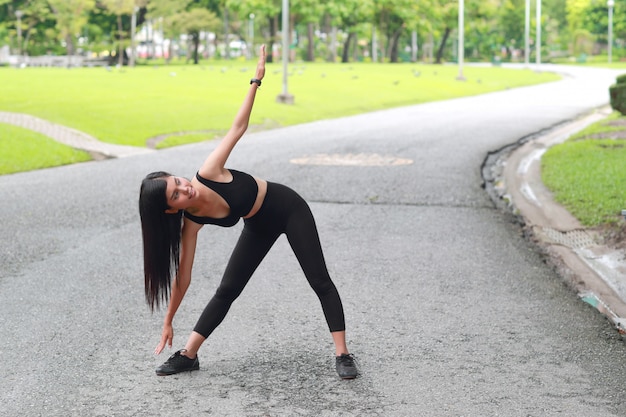 Young healthy and sporty woman do yoga stretching outdoor 