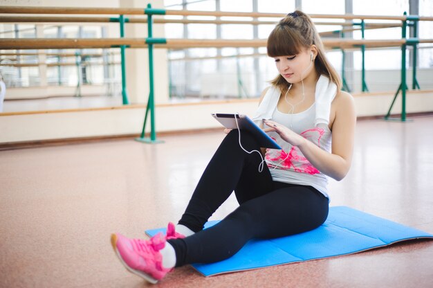 Young healthy woman take a rest in fitness