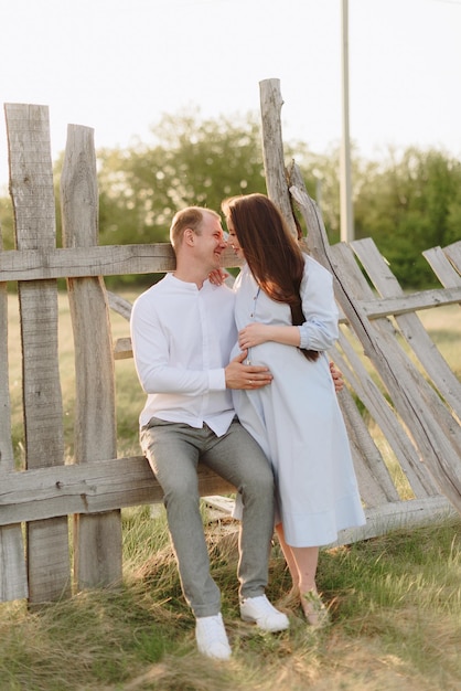 Young heterosexual pregnant couple in an outdoor park