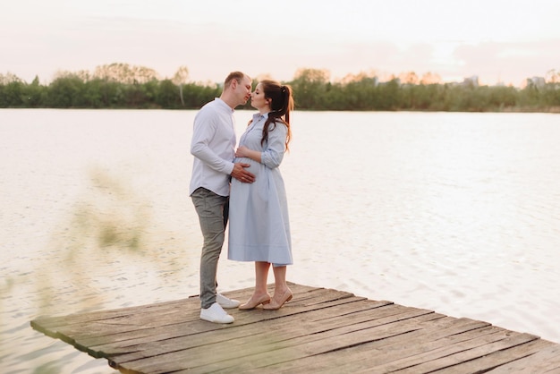 Young heterosexual pregnant couple in an outdoor park