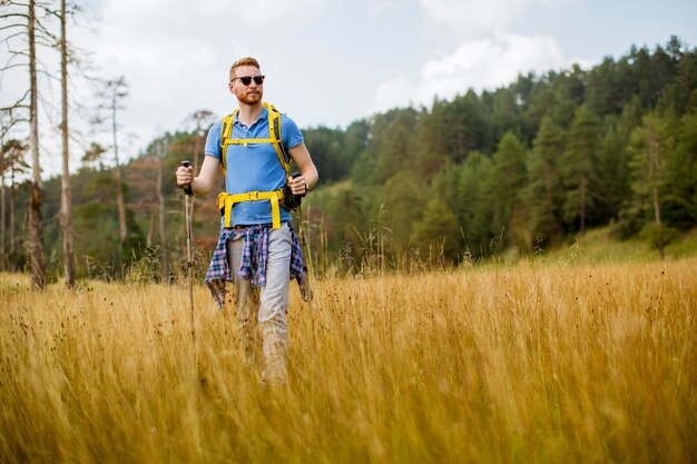 Young hiker enjoys a sunny day on the mountain