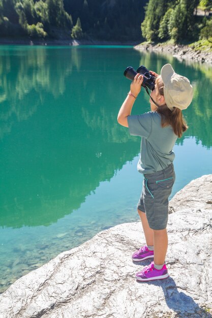 young hiker watches the panorama with the telescope