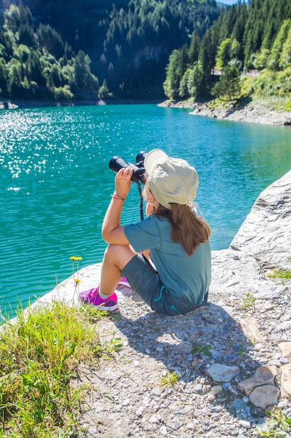 young hiker watches the panorama with the telescope