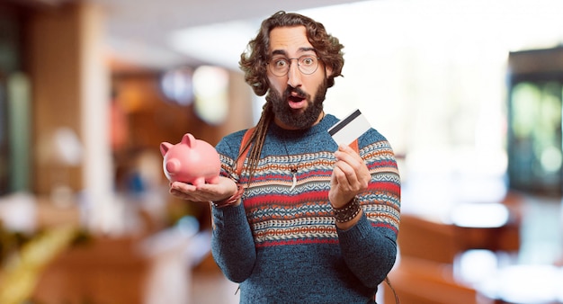 Photo young hippie man with a piggy bank