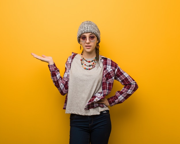 Young hippie natural woman holding something with hand