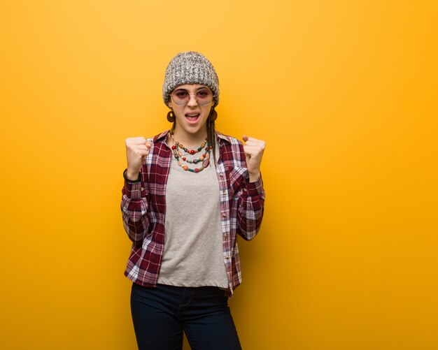 Young hippie natural woman screaming very angry and aggressive