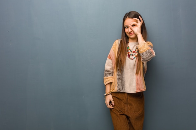 Young hippie woman confident doing ok gesture on eye