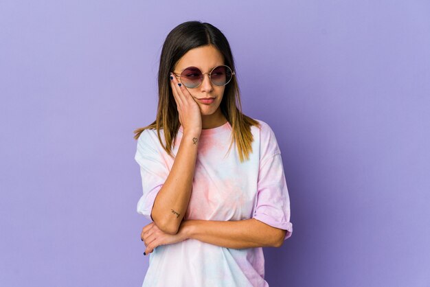 Young hippie woman isolated on purple background who is bored, fatigued and need a relax day.