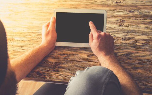 Young hipster business man using digital tablet