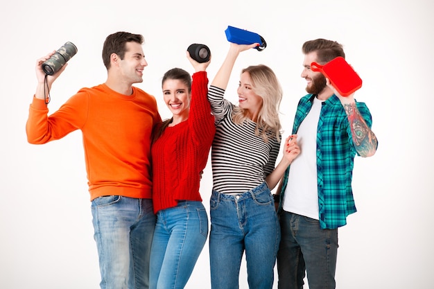 Young hipster company of friends having fun together smiling listening to music on wireless speakers