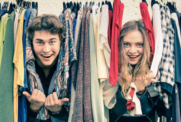 Young hipster couple in love at the weekly cloth market