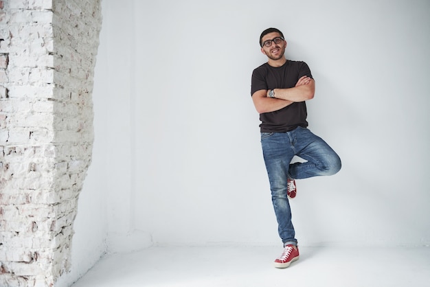 Young hipster guy wearing glasses laughing happily isolated on white background.