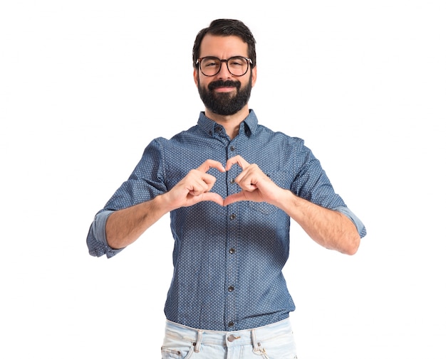 Photo young hipster man making heart sign
