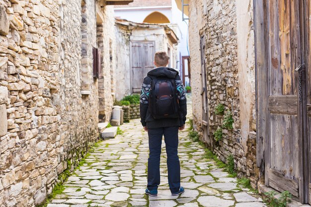 Young hipster man traveling backpacker outdoor. Travel concept.