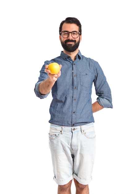 Young hipster man with apple over white background