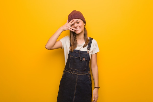 Young hipster woman embarrassed and laughing at the same time