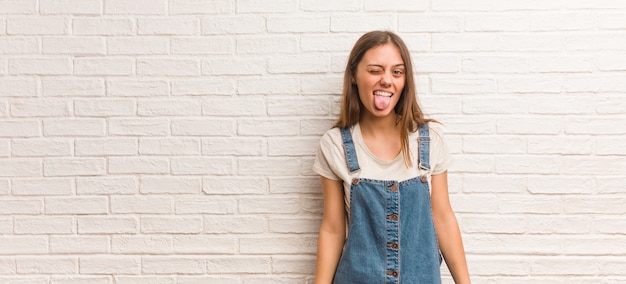 Young hipster woman funnny and friendly showingngue