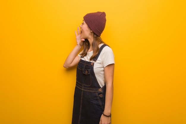 Young hipster woman whispering gossip