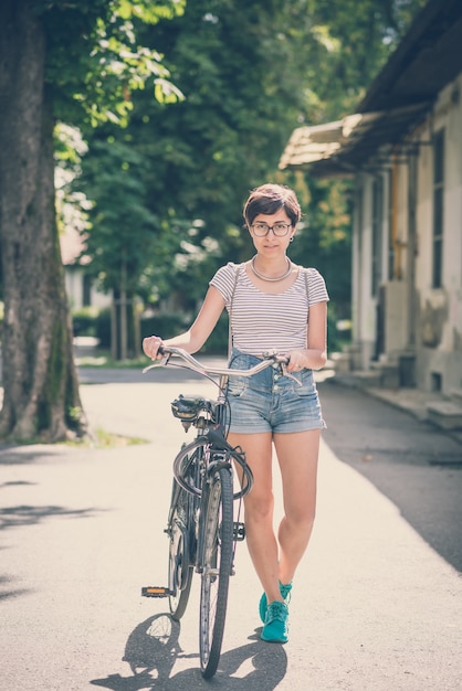 young hipster woman with bike