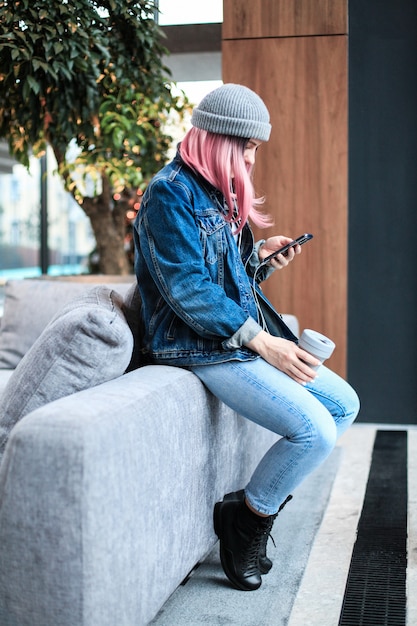 Young hipster woman with pink hair and hat