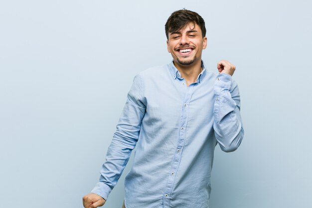 Young hispanic business man dancing and having fun.