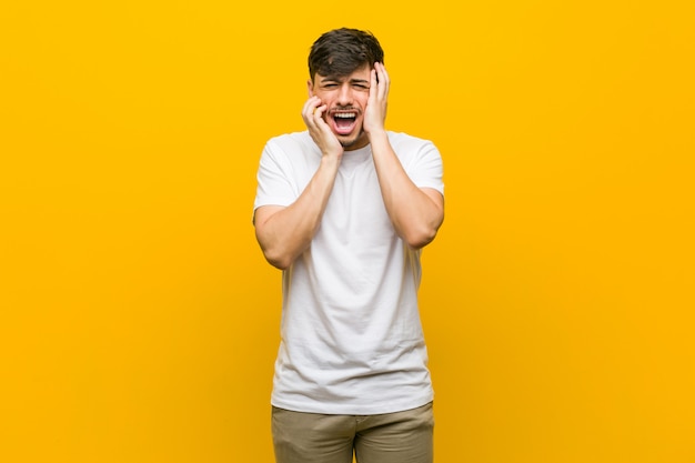 Young hispanic casual man whining and crying disconsolately.