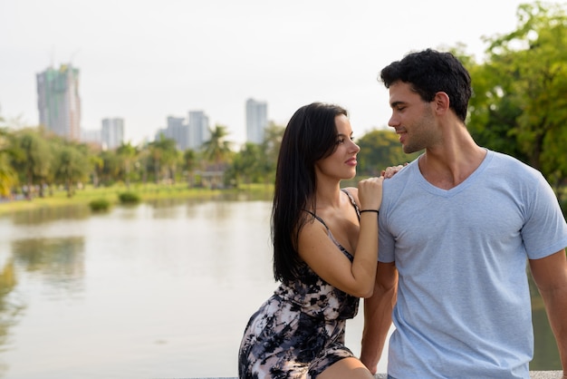 Young Hispanic couple relaxing in the park together