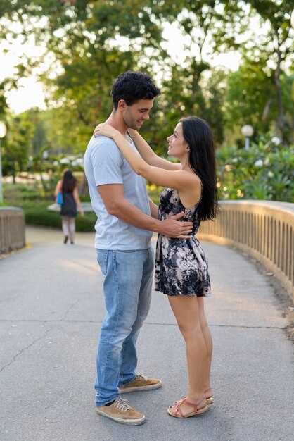 Young Hispanic couple relaxing in the park together