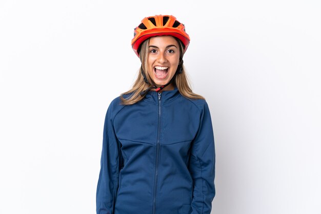 Young hispanic cyclist woman isolated on white background with surprise facial expression