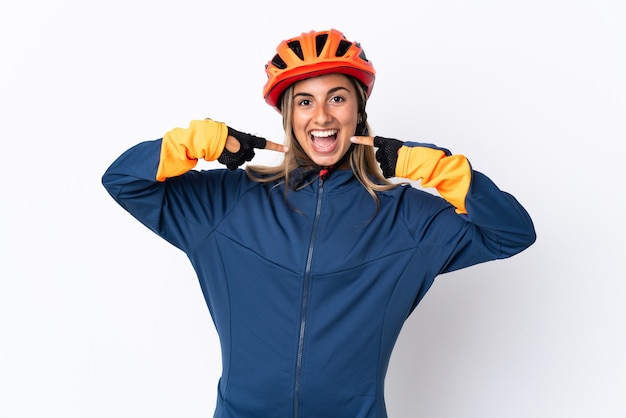 Young hispanic cyclist woman isolated on white giving a thumbs up gesture