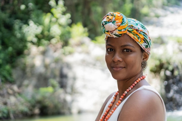 Young Hispanic girl with turban in the middle of the river