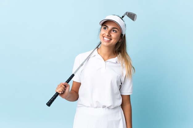 Young hispanic golfer woman isolated