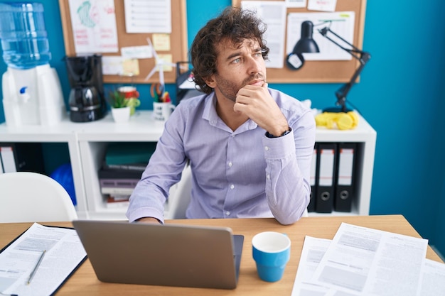 Young hispanic man business worker using laptop working at office