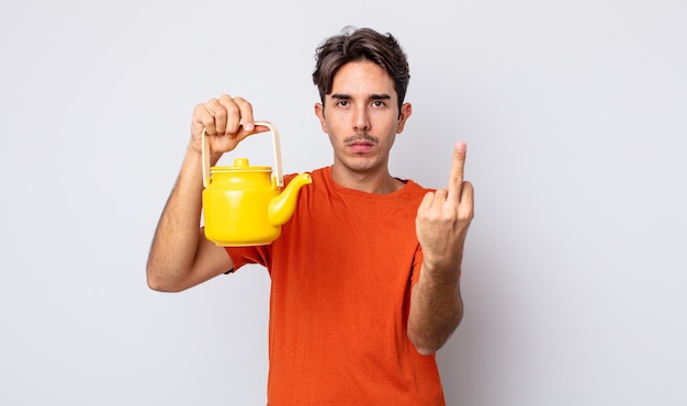 Young hispanic man feeling angry annoyed rebellious and aggressive teapot concept
