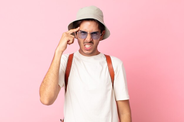 Young hispanic man feeling confused and puzzled, showing you are insane. summer concept