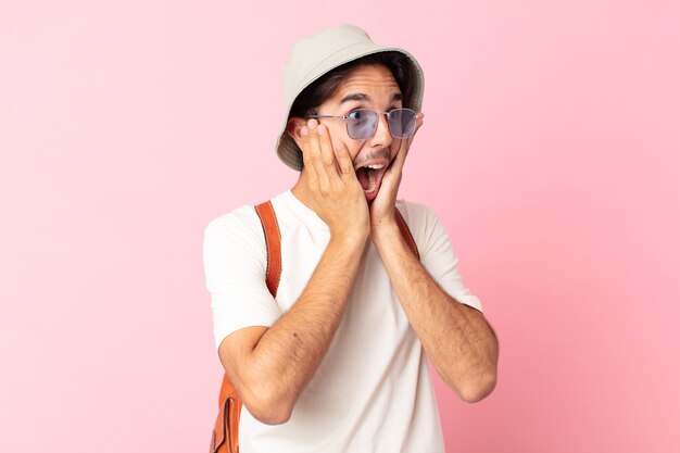 Young hispanic man feeling happy, excited and surprised. summer concept