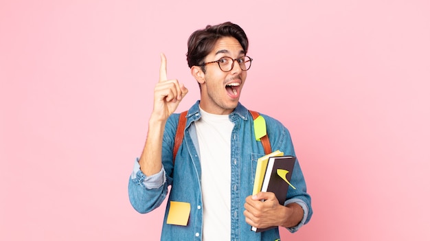 Young hispanic man feeling like a happy and excited genius after realizing an idea. student concept