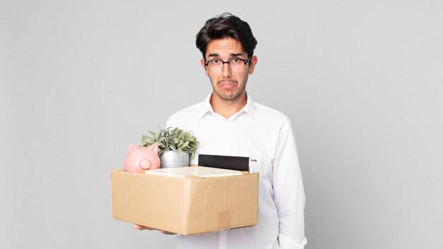 Young hispanic man feeling sad and whiney with an unhappy look and crying. dismissal concept