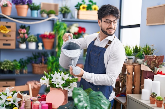 花屋で自信を持って花に水をやるヒスパニック系の若い男性の花屋