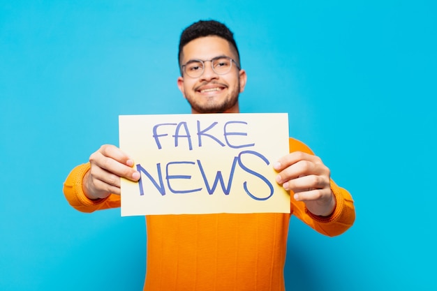 Photo young hispanic man happy expression fake news concept