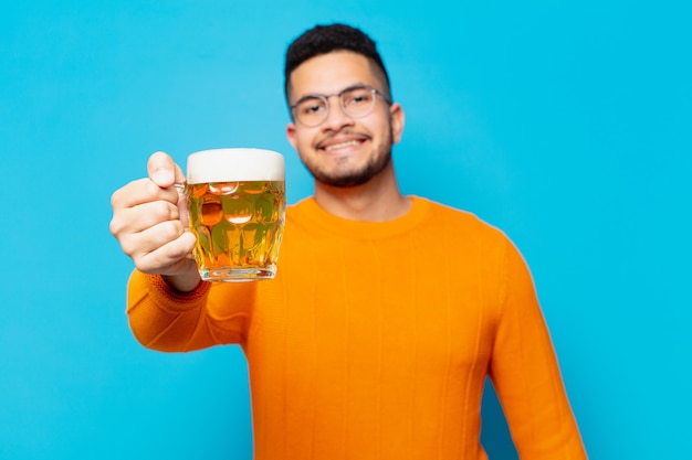 Young hispanic man happy expression and holding a beer